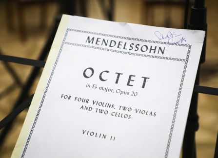 A photograh. A sheet music on a stand, titled octet